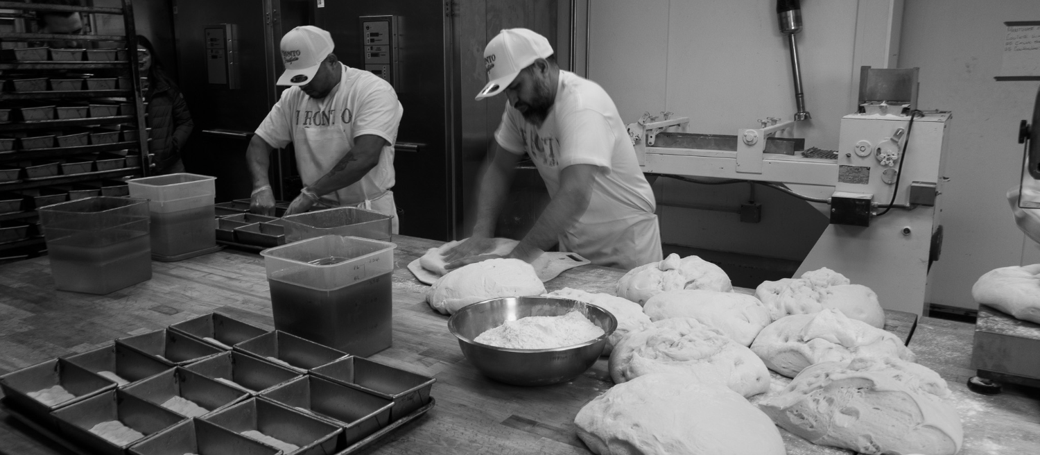 Bakers shaping dough on the Chicago Gourmet Bakery floor